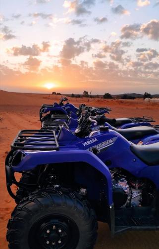 a group of atvs in the desert at sunset at Infinity sahara camp in Merzouga
