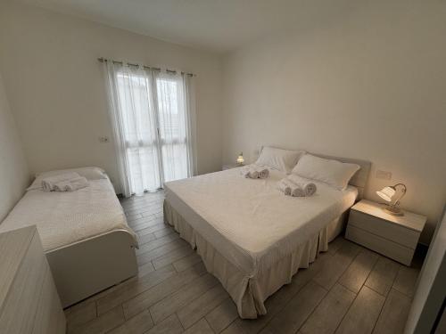 En eller flere senge i et værelse på Casa Efix - Residence Il Gabbiano