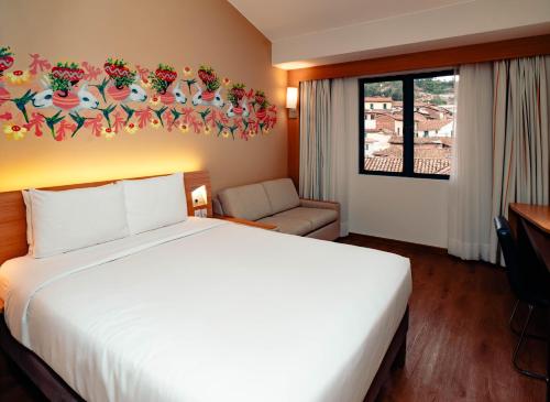 Postel nebo postele na pokoji v ubytování Novotel Cusco