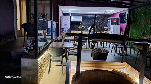 a restaurant with tables and chairs in a room at Mon Ami Boutique Hotel in Shkodër