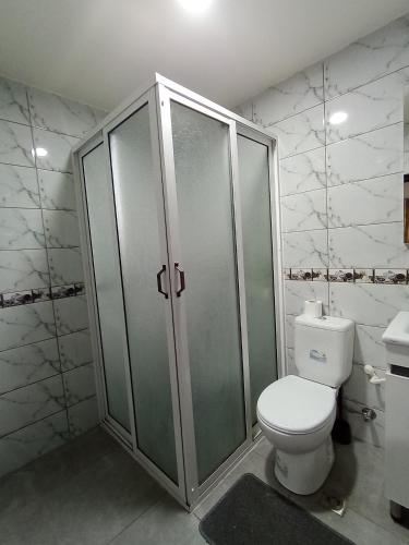 a bathroom with a toilet and a shower and a sink at résidence sara in Fez
