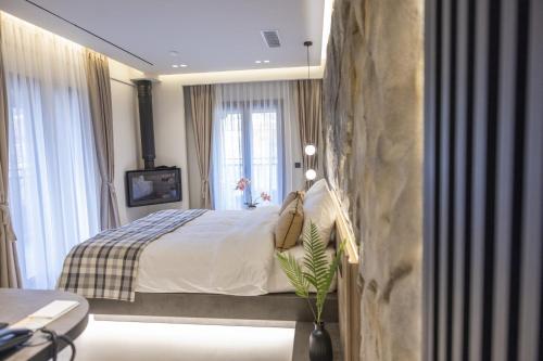 En eller flere senge i et værelse på Polyzos Luxury Suites Meteora #3 - Adults Friendly
