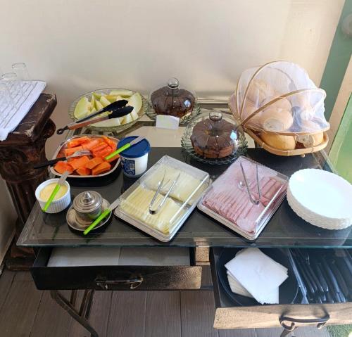 a table with plates of food on top at Hotel Tucano in Inocência