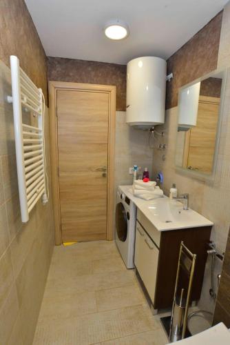 a small kitchen with a sink and a washing machine at Apartments Boka bay in Kotor