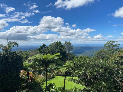 a view of a lush green field with trees at Mountain Retreat Scenic Getaway with BBQ in Mount Tamborine