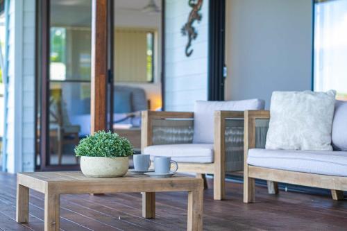 a coffee table with a potted plant on a patio at Mountain Retreat Scenic Getaway with BBQ in Mount Tamborine
