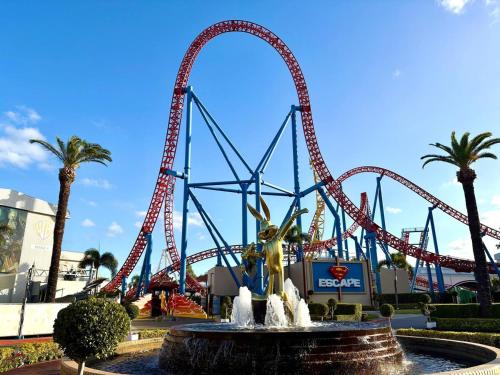 a roller coaster at a theme park with a water fountain at Mountain Retreat Scenic Getaway with BBQ in Mount Tamborine