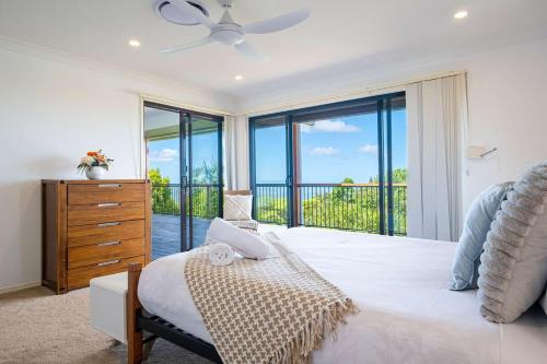 a bedroom with a bed and a large window at Mountain Retreat Scenic Getaway with BBQ in Mount Tamborine