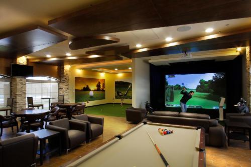 a living room with a pool table and a tv at Staybridge Suites Chihuahua by IHG in Chihuahua