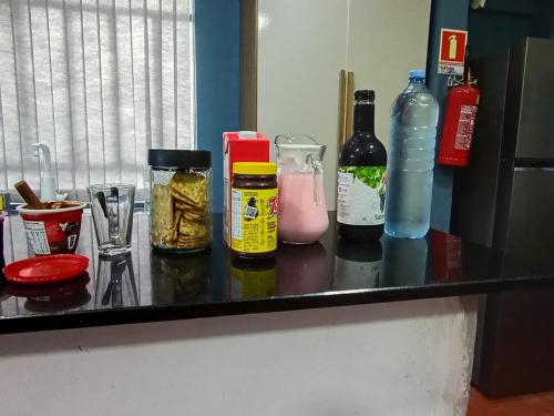 a counter with bottles of food and drinks on it at New hotel in Alegrete