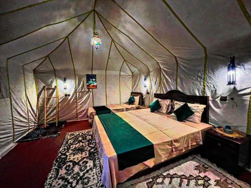 a bedroom with a bed in a tent at Camp luxury Merzouga in Merzouga