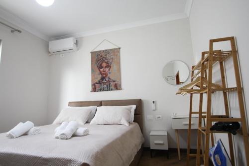 a bedroom with a bed and a painting on the wall at Villa Reve de Tirana in Tirana