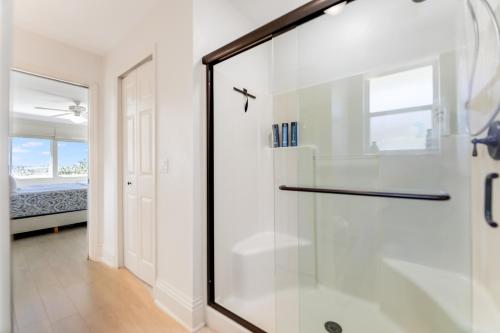 a bathroom with a shower with a glass door at Turtle Caye in Sanibel