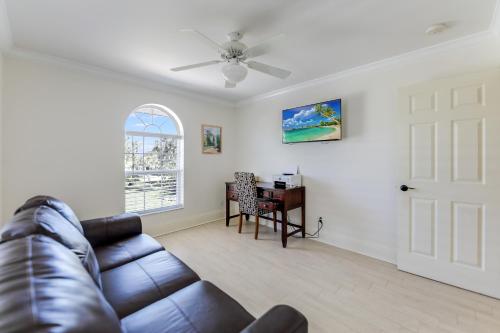 a living room with a leather couch and a table at Turtle Caye in Sanibel