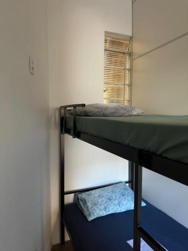 two bunk beds in a room with a window at Quartos para alugar em itu Hostel Jm in Itu
