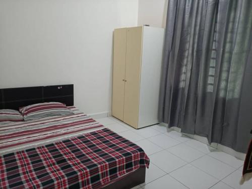 a bedroom with a bed and a dresser and curtains at Zafirah Homestay Changlun in Changlun