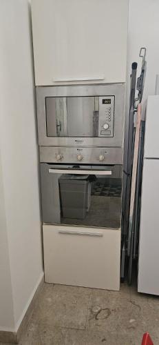 a kitchen with an oven with a microwave at Garibaldi Apartment Sanremo in Sanremo