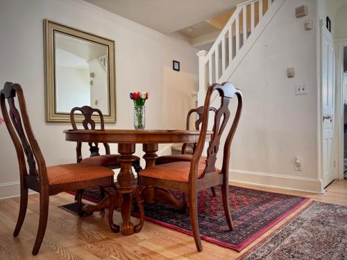 a dining room table with chairs and a mirror at Providence & 18th in Chester