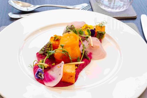 a white plate of food on a table at Horsted Place Hotel in Uckfield