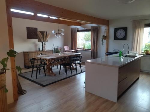 a kitchen and living room with a table and chairs at Jenny's Guest House in Kristianstad