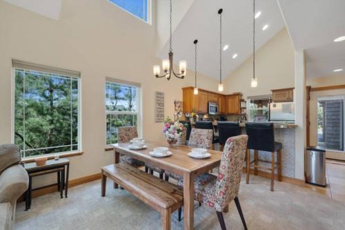 a dining room and kitchen with a table and chairs at Lakefront Retreat Hot Tub & Semi-Private Dock in Rockaway Beach