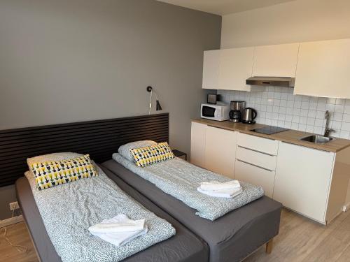 a small kitchen with two beds in a room at Ocean Breeze Apartments in Selfoss