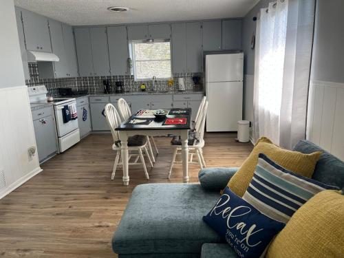 a living room with a couch and a table in a kitchen at The Lake-wood Ranch in Belton
