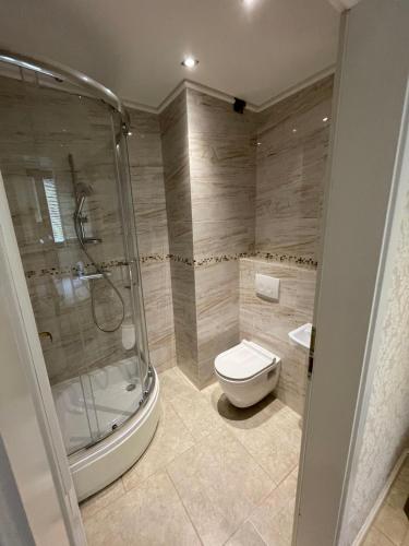 a bathroom with a shower and a toilet and a sink at President Apartments by WarsawResidence Group in Warsaw