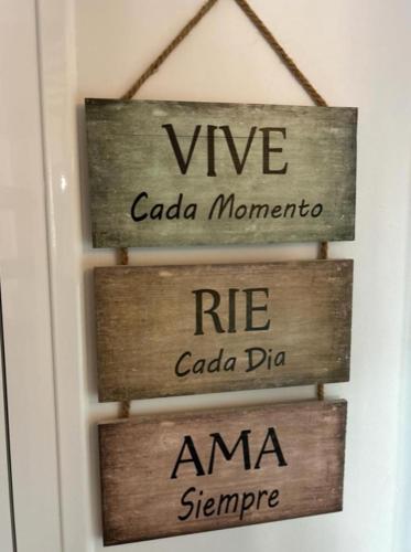 a couple of wooden signs hanging on a door at Casa María Lanjarón in Lanjarón
