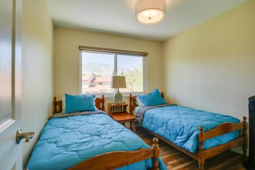 a bedroom with two beds and a window at Townhome with Pool Access, Near Dtwn Palm Springs! in Palm Springs