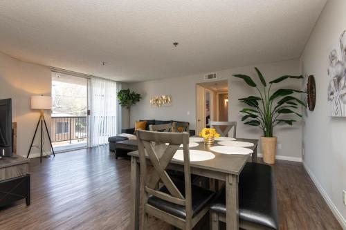 a living room with a dining room table and a couch at Chic Hollywood Retreat 2Bed Rooftop Pool with Iconic Views in Los Angeles