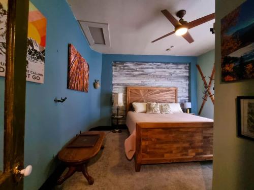 a bedroom with a bed and a ceiling fan at A Charming Mountain Getaway in Historic Como in Como