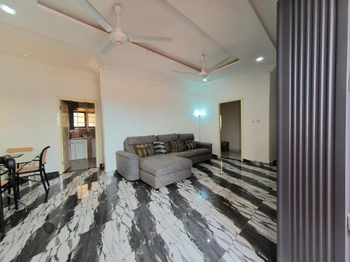 a living room with a couch and a table at Empress White House Accra in Tema