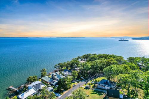 an aerial view of a house next to the water at Seaside Escape in North Arm Cove