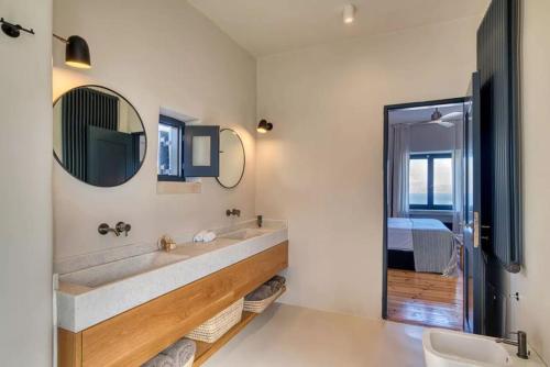 a bathroom with a large sink and a mirror at Villa Hestia - Full estate in Kóstos