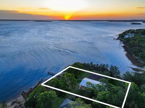 an aerial view of an island in the water at Grand Esplanade in North Arm Cove