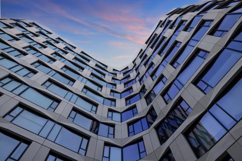 a tall building with windows against a blue sky at Timbri Hotel San Francisco, Curio Collection by Hilton in San Francisco