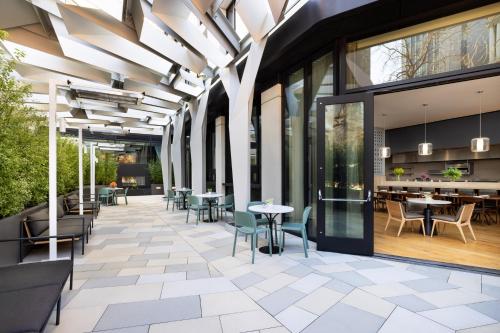 a patio with tables and chairs in a building at Timbri Hotel San Francisco, Curio Collection by Hilton in San Francisco