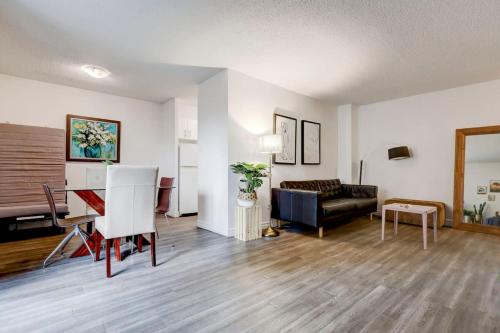 a living room with a couch and a table at Inviting 1BR on Rene Levesque in Montréal