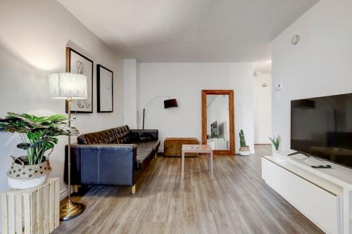 a living room with a couch and a table at Inviting 1BR on Rene Levesque in Montréal