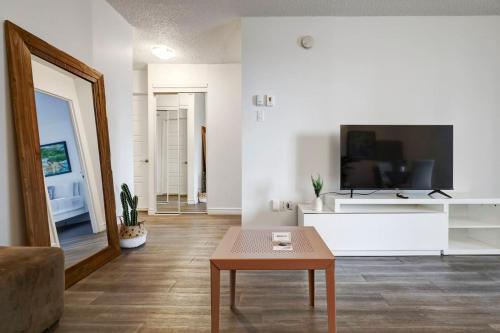 a living room with a tv and a coffee table at Inviting 1BR on Rene Levesque in Montréal