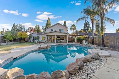 a swimming pool in front of a house at Huge House-Yard-Pool Hot Tub in Citrus Heights