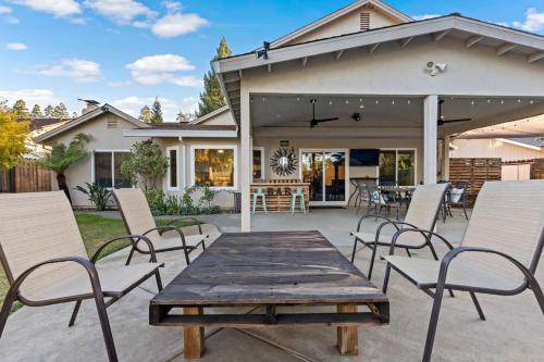 a patio with a wooden table and chairs at Huge House-Yard-Pool Hot Tub in Citrus Heights