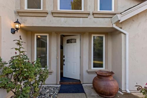 a front door of a house with a large vase at Huge House-Yard-Pool Hot Tub in Citrus Heights