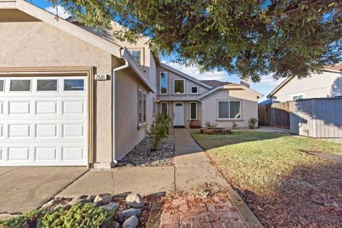 a house with a white garage door at Huge House-Yard-Pool Hot Tub in Citrus Heights