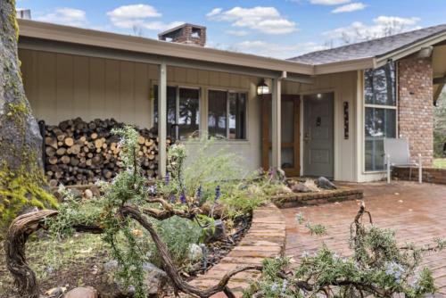 a house with a pile of logs at Mid-Century-Modern Mountain Gem in Placerville