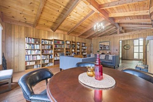 a room with a table and chairs in a library at Mid-Century-Modern Mountain Gem in Placerville