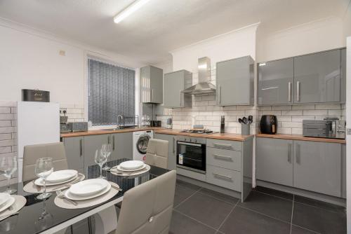 a kitchen with a table with plates on it at Varley View - Colne Sleep 5 in Colne