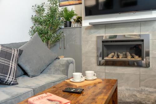 a living room with a couch and a fire place at Varley View - Colne Sleep 5 in Colne