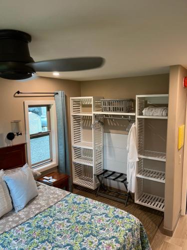 a bedroom with a bed and white shelving at Mahana House Country Inn in North Hilo